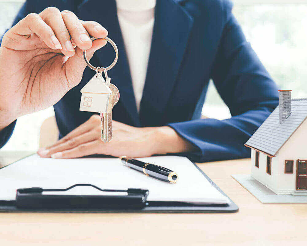woman handing the keys to someone