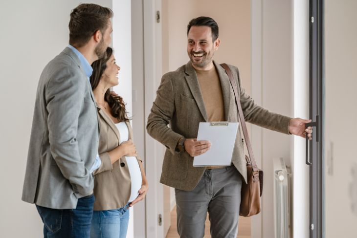 helpful estate agent showing down a pregnant couple